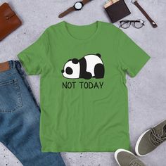 "Love pandas? Take a little bit of panda cuteness wherever you go with our comfy and adorable Not Today Panda unisex t-shirt. Great for either men or women. It feels soft and lightweight, with the right amount of stretch. Comes in ten great colors. Snatch one today! Also great as a gift for the panda lover in your life. Looking for a darker color? Check out our white pocket version! PRODUCT DETAILS * Fabric weight: 4.2 oz (142 g/m2) * Pre-shrunk fabric * Shoulder-to-shoulder taping * Side-seamed Cute Green T-shirt With Funny Text, Green T-shirt With Funny Print As Gift, Cute Funny Print T-shirt For Everyday, Cute Funny Print T-shirt For Gift, Cute T-shirt With Funny Text As Gift, Funny Panda, Panda Gifts, Kawaii Panda, Panda Tshirt