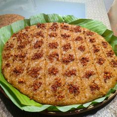 a large cake sitting on top of a green leaf covered plate