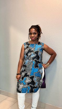 This is a beautiful Mix and Match African Print Tunic Top made with two different fabrics. Whether you opt to dress up or dress down, its perfect for any outing. Wear this with any regular pants or jeans. It is definitely a head turner for its elegance and bright colors. You're sure to stand out from the crowd on this top because it exudes confidence and class. This Top is already made and ready to wear. Size: US S/M Model typically wears a Medium and is 5ft tall. Available as a custom order. Just send a message to discuss further details. We will do all we can to ensure you love your top and promptly address any additional requests or issues you may have. If you'll like a custom outfit made just for you, just go ahead and start a conversation by clicking on the 'contact seller' button. Th Blue Batik Print Sleeveless Dress, Blue Sleeveless Batik Print Dress, Blue Sleeveless Dress With Batik Print, Fitted Sleeveless Batik Print Dress, Blue Fitted Tunic, Blue Mixed Print Dress, Fitted Blue Patchwork Blouse, Fitted Bohemian Multicolor Tunic, Multicolor Fitted Tunic Dress