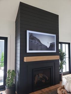 a living room with a fireplace and pictures on the wall