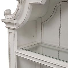 an old white wooden shelf with glass shelves