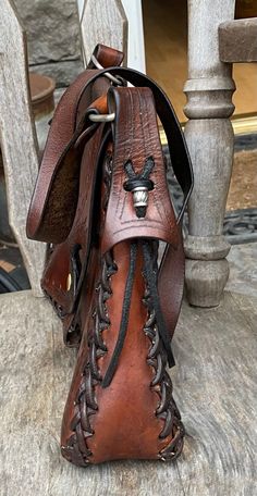 Western Style Brown Hand Tooled Shoulder Bag, Bohemian Brown Saddle Bag For Festivals, Western Brown Satchel Shoulder Bag, Western Style Hand Tooled Brown Shoulder Bag, Brown Crossbody Saddle Bag For Festival, Western Style Brown Shoulder Bag With Adjustable Strap, Western Brown Shoulder Bag With Adjustable Strap, Rustic Handmade Brown Shoulder Bag, Handmade Rustic Brown Shoulder Bag