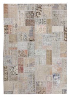 an old patchwork rug with many different colors and patterns on the ground, including beiges