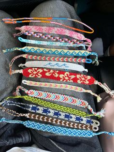 a bunch of bracelets that are on the back of someone's car seat