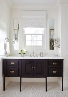 a bathroom with two sinks, mirrors and a window in the wall above it is white tile flooring