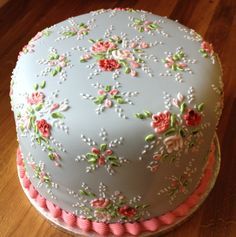 a decorated cake sitting on top of a wooden table