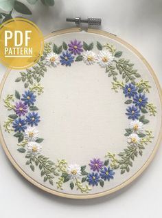 an embroidery pattern with blue and white flowers