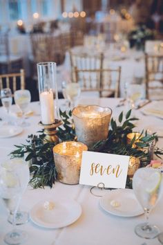 the table is set with candles and place cards