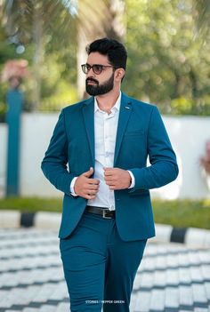 a man in a blue suit and white shirt