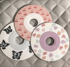 three paper plates with hearts and butterflies on them