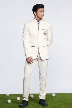 Off white bandhgala in suiting fabric base featuring SNCC patch logo along with contrasting stripe piping.
Component: 1
Pattern: Embroidered
Type Of Work: Patch Logo
Neckline: Band Collar
Sleeve Type: Full
Fabric: Suiting fabric
Color: Off White
Other Details: 
Front shank buttons
Contrasts striped piping
Note: Inner shirt, tie and pant worn by the model is not for sale
Occasion: Reception - Aza Fashions Off White Unstitched Bandhgala With Long Sleeves, Unstitched Off White Bandhgala With Long Sleeves, Unstitched Embroidered Off White Bandhgala, Fitted Off-white Bandhgala With Cutdana, White Embroidered Fitted Bandhgala, Straight Fit Pants, Band Collar, Suit Fabric, Wool Pants