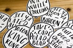 six black and white stickers with words on them