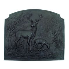 a metal plaque depicting two deer in the woods