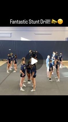 a group of cheerleaders standing on top of a basketball court