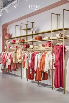 a clothing store with clothes hanging on racks