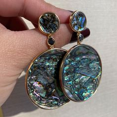 JE0450 'Innate' Mother Of Pearl Round Abalone Shell Earrings in 18K Yellow Gold with Black diamond Stone Size: 38 mm (Large stone) x 12 mm (Small stone) Approx. Wt: 0.33 Carats (Black Diamonds) Evening Multi-stone Round Earrings, Formal Multi-stone Round Earrings, Elegant Multi-stone Round Earrings, Luxury Mother Of Pearl Jewelry With Matching Earrings, Luxury Multi-stone Earrings, Luxury High Luster Oval Earrings, Evening Round Gemstone Earrings, Round Multi-stone Earrings For Anniversary, Anniversary Multi-stone Round Earrings