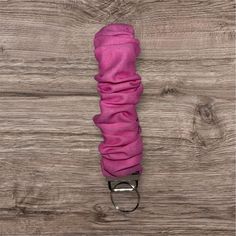 a pink umbrella on a wooden floor with it's cover pulled up to the side