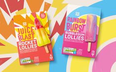 two popsicles with rainbow burst and rocket lollies on them are shown in front of an abstract background