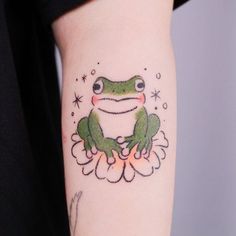 a green frog sitting on top of a flower with stars in the sky behind it