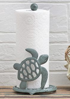 a toilet paper holder with a turtle on it