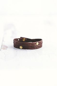 Made for the true warrior, our Double Warrior wrap is a narrow leather bracelet that wraps around the wrist twice and features two flat antique brass rivet accents. **Contents** * Lambskin leather, antique brass hardware * Button clasp closure * Handmade **Care/Import** * Made in the USA **Dimensions** * Adjustable to fit wrist sizes 6.5”-8” | Giving Bracelets Antique Brass Double Warrior Wrap Bracelet at Free People in Brown Adjustable Gold Leather Wrap Bracelet, Adjustable Vintage Leather Bracelet With Rivets, Vintage Adjustable Leather Bracelet With Rivets, Brown Leather Wrap Bracelet For Festivals, Leather Jewelry With Rivets For Gifts, Leather Jewelry With Rivets As A Gift, Adjustable Leather Bracelet With Rivets For Gift, Adjustable Leather Bracelet With Rivets, Adjustable Riveted Leather Bracelet Gift