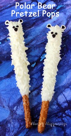 two polar bear pretzel pops are shown on a blue background