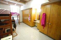 a bedroom with bunk beds and wooden cabinets