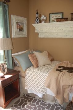 a bedroom with a bed, wicker chair and pictures on the wall above it