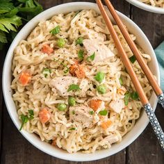 two bowls of chicken noodle soup with chopsticks