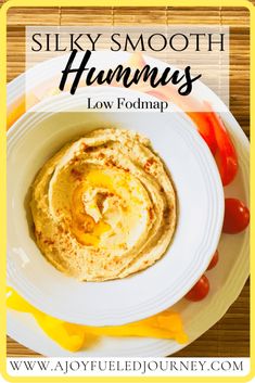 a plate with hummus on it next to tomatoes and ketchup, along with the text silky smooth hummus gluten free dairy free low fodmap