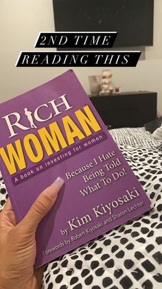 a person holding up a purple book in their hand with the title rich woman on it