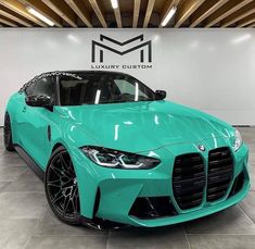 a blue sports car parked in a showroom