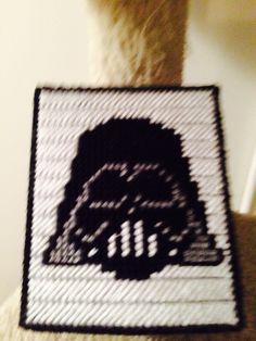 a close up of a person wearing a star wars knitted badge