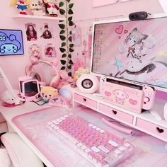 a desk with a keyboard, mouse and other items on it in a pink room