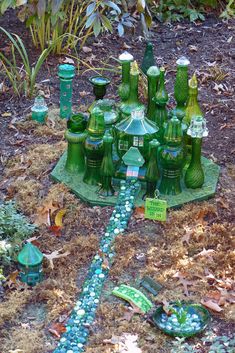 many green glass bottles sitting on the ground