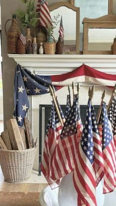 several american flags are hanging in front of a fireplace