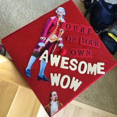 a red graduation cap with an image of george washington on it that says, you're on your own awesome wow