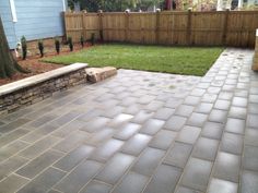 a brick patio in front of a blue house