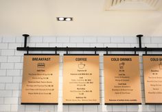 three menus hanging on the wall in a restaurant