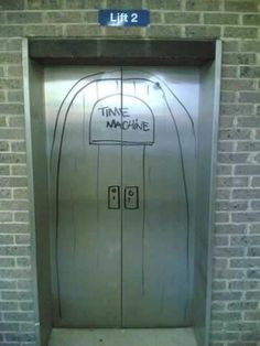 a door with the words time machine written on it in front of a brick wall