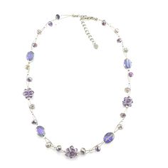 A lovely glass and crystal bead necklace featuring iridescent faceted purple and silver glass crystal beads and bead clusters. This 16 inch (41cm) bead necklace is strung on silver metal wire with clear glass spacers and has a 2.5 inch (6.5cm) extension chain. It comes in a Fatlip branded suedette pouch ready to make a perfect gift for someone special.  This is a handmade item so the design may vary slightly from the one shown in the photos. All of our jewellery is fully inspected and packed wit Purple Glass Beaded Necklaces With Round Beads, Purple Glass Beaded Necklace With Round Beads, Purple Adjustable Crystal Necklaces With Faceted Beads, Purple Glass Beaded Chain Jewelry, Silver Glass Necklaces With Faceted Beads, Silver Glass Necklace With Faceted Beads, Silver Necklace With Faceted Beads, Silver Crystal Beaded Necklaces With Colorful Beads, Purple Wire-wrapped Necklaces With Round Beads