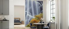 a dining room with a waterfall wall mural