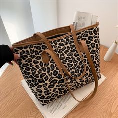 This animal print shoulder bag is perfect for your daily life. It features an animal print design and is made from high-quality materials. Made of high-quality materials, this tote bag features a zipper closer so you won't have to worry about any unwelcome intruders while carrying your personal items. Trendy Rectangular Canvas Bag For Fall, Trendy Fall Canvas Bag For Everyday Use, Casual Black Bag With Animal Design, Casual Leopard Print Travel Bag, Fall Canvas Shoulder Bag, Trendy Travel Bags With Animal Design, Black Bag With Animal Design For Everyday Use, Casual Everyday Bag With Animal Design, Casual Everyday Bags With Animal Design