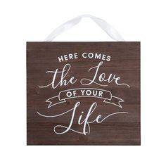 a wooden sign that says, here comes the love of your life with white lettering