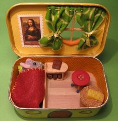 an open tin can with a doll house inside