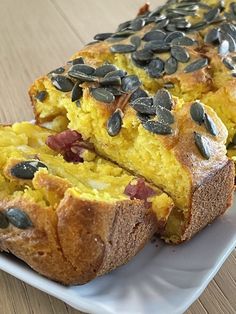 two slices of bread on a plate with pumpkin seeds