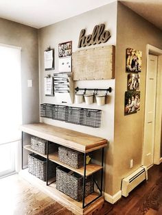 the entryway is clean and organized with baskets on the shelf, hanging from the wall