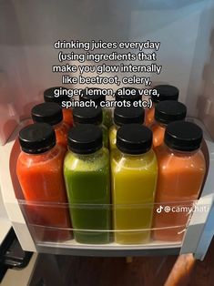 a refrigerator filled with lots of different types of juices in it's door