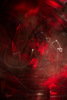 blurry photograph of red and white lights in the night sky with an abstract background