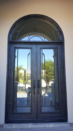 a double door with arched glass on the outside